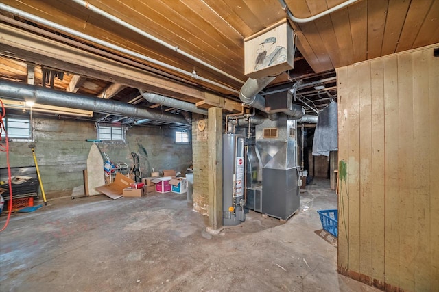 basement featuring heating unit and water heater