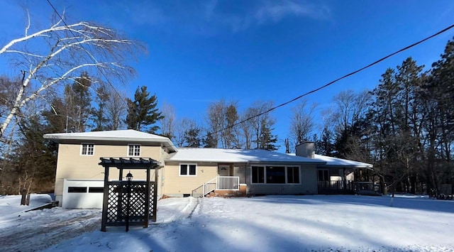 view of snow covered back of property