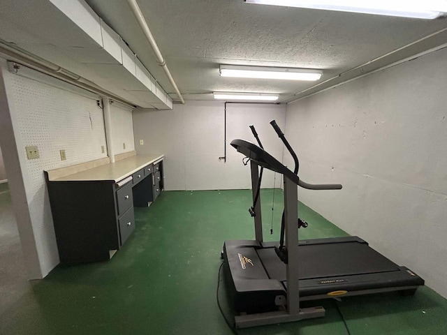 workout area featuring a textured ceiling