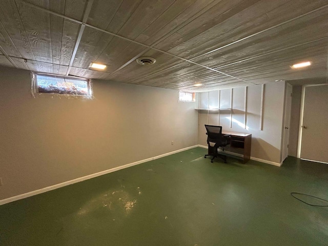 basement with wood ceiling and a wealth of natural light