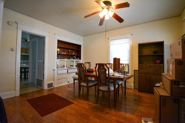 dining room with dark hardwood / wood-style flooring, built in features, and ceiling fan