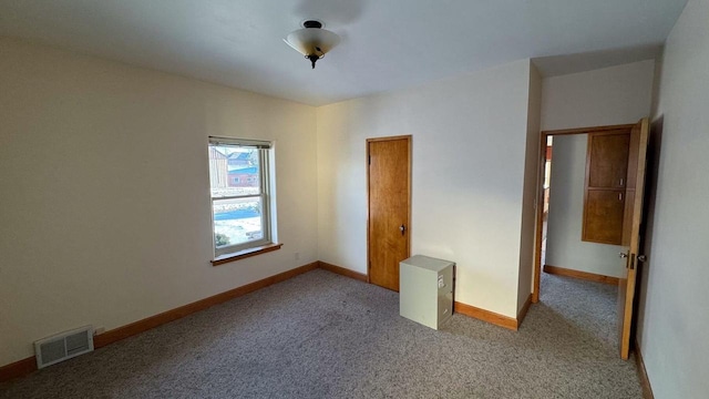 unfurnished bedroom featuring light carpet