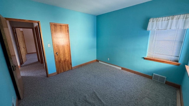 unfurnished bedroom featuring a baseboard radiator and carpet flooring