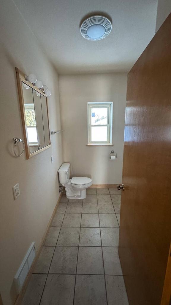 bathroom featuring tile patterned floors, plenty of natural light, and toilet