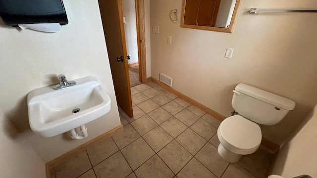 bathroom featuring tile patterned floors, toilet, and sink