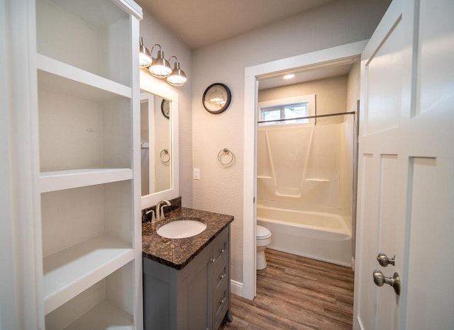 bathroom with bathtub / shower combination, vanity, toilet, and wood finished floors