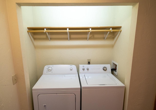 clothes washing area featuring washer and dryer