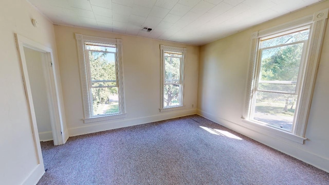 carpeted spare room with baseboards