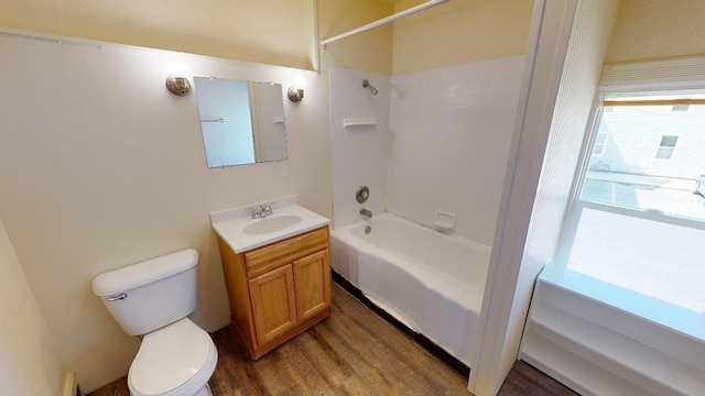 full bathroom with shower / tub combination, vanity, hardwood / wood-style floors, and toilet