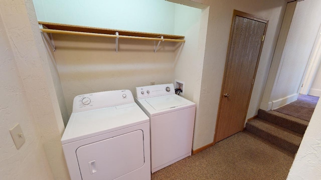 laundry room featuring light carpet and washer and dryer