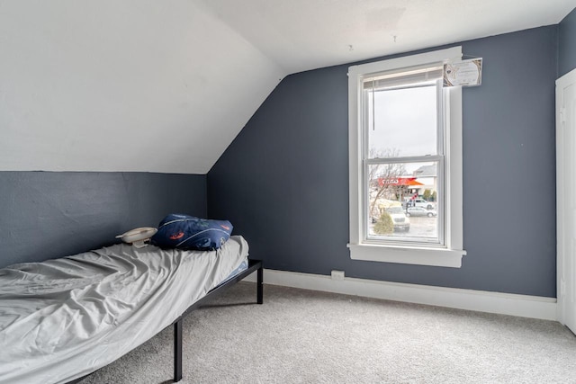 carpeted bedroom featuring lofted ceiling