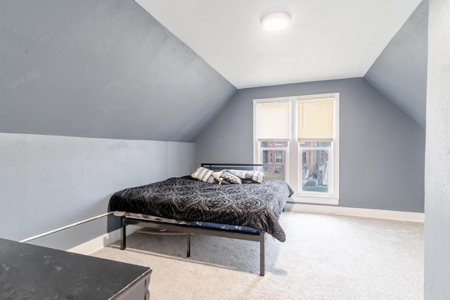 bedroom with lofted ceiling and carpet floors