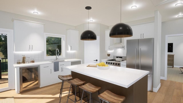 kitchen with pendant lighting, white cabinetry, stainless steel fridge, a center island, and range