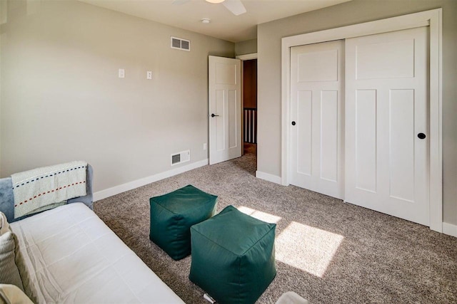 living area with carpet floors and ceiling fan