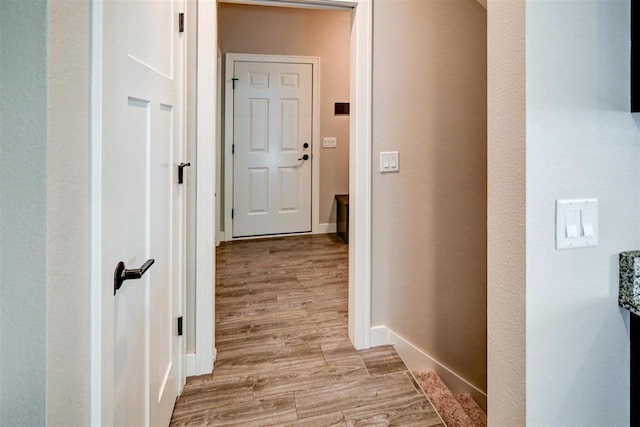 corridor with light hardwood / wood-style floors