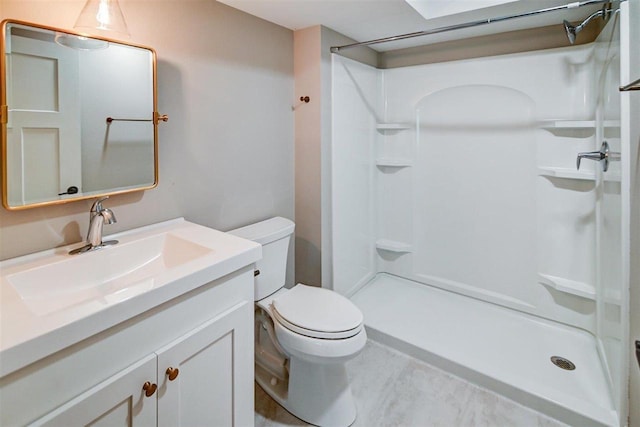 bathroom with vanity, toilet, and walk in shower