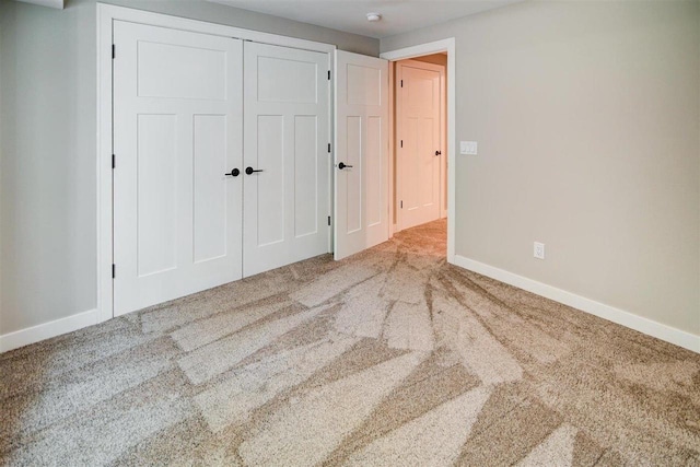 unfurnished bedroom featuring a closet and carpet