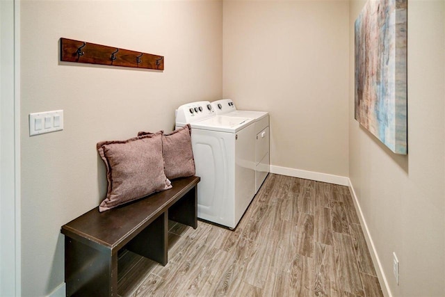 washroom featuring light hardwood / wood-style floors and washer and dryer