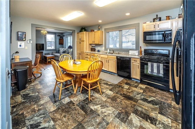 kitchen with sink, light brown cabinetry, and black appliances