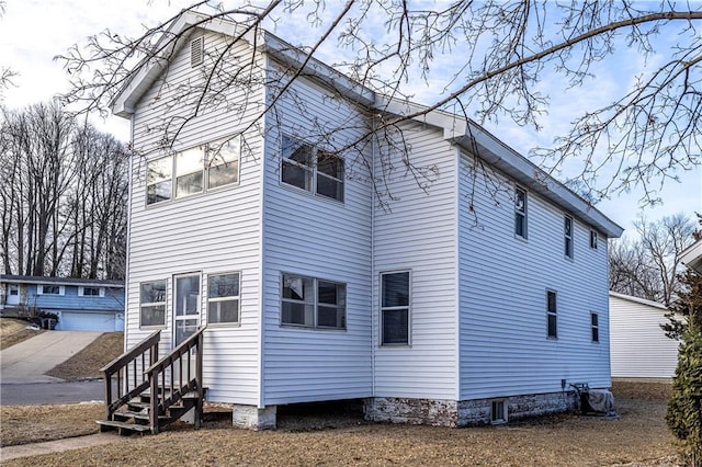 view of side of home featuring an outbuilding and a garage