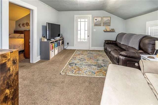 carpeted living room featuring vaulted ceiling