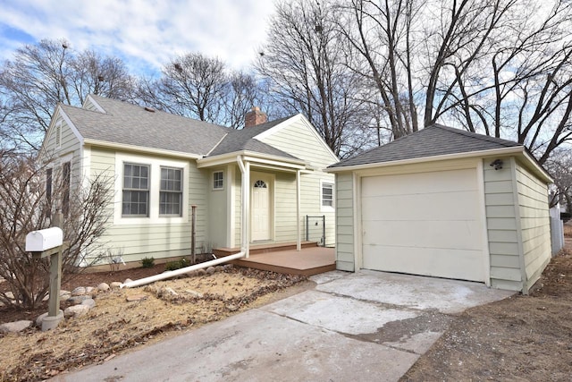 single story home with an outbuilding and a garage