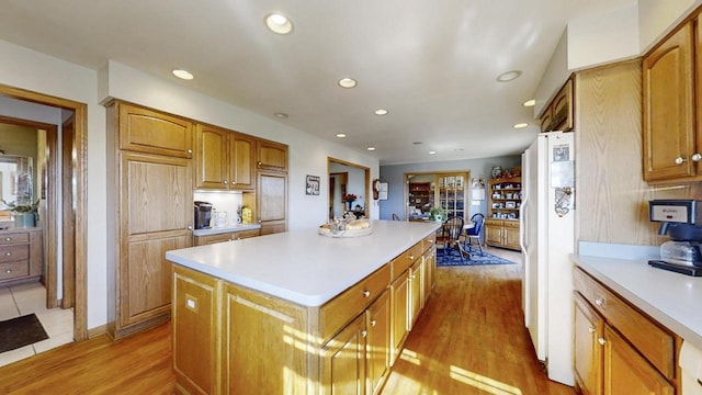 kitchen featuring a center island, white fridge, and light wood-type flooring