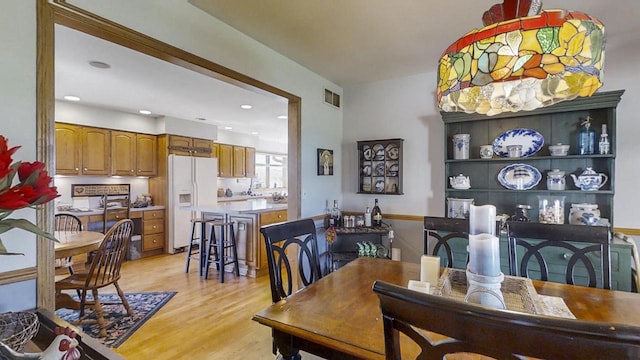 dining space with light hardwood / wood-style floors