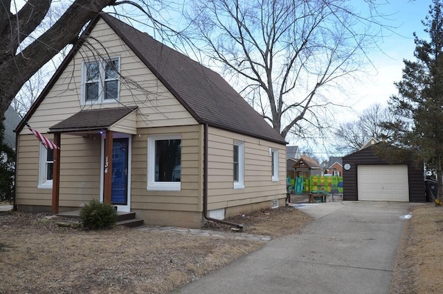 bungalow featuring an outbuilding and a garage