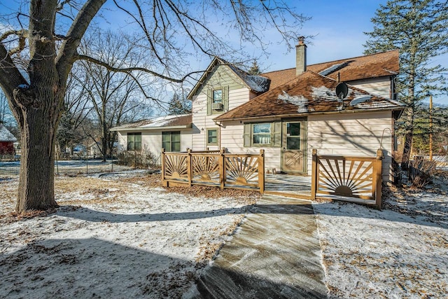 view of snow covered rear of property