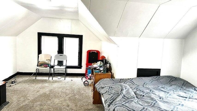 bedroom featuring vaulted ceiling and carpet