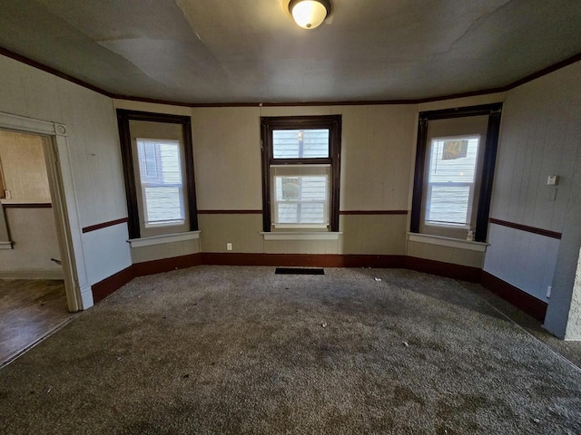 carpeted spare room with crown molding