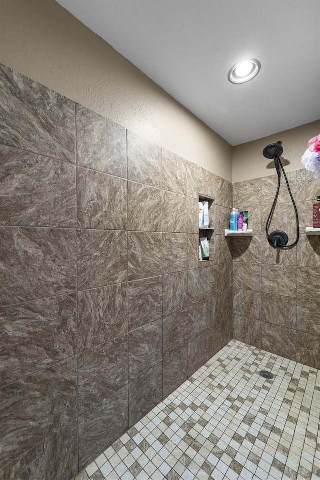 bathroom with a tile shower