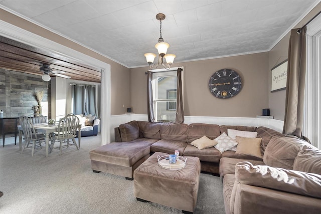 carpeted living room with crown molding and a chandelier