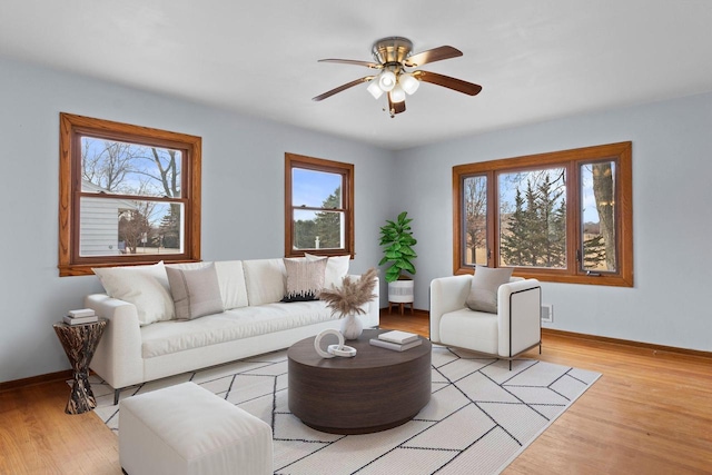 living room featuring light wood-type flooring and ceiling fan