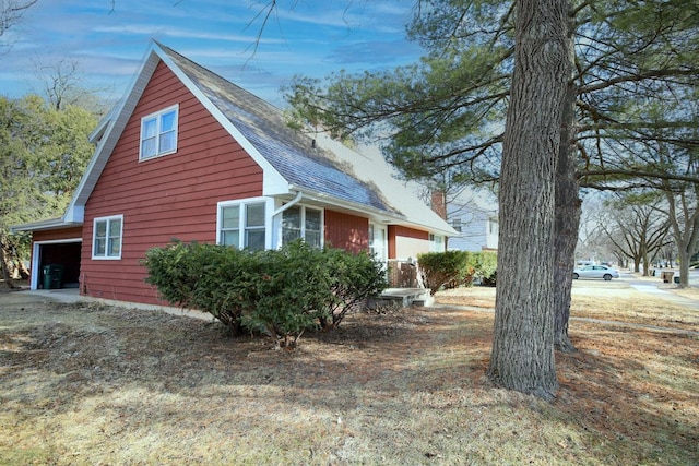 view of property exterior featuring a shingled roof