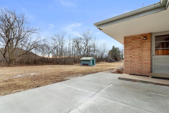 view of patio featuring a storage unit