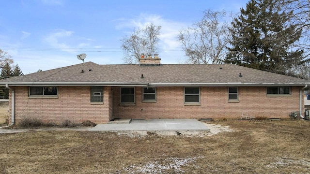 back of house with a patio area and a lawn