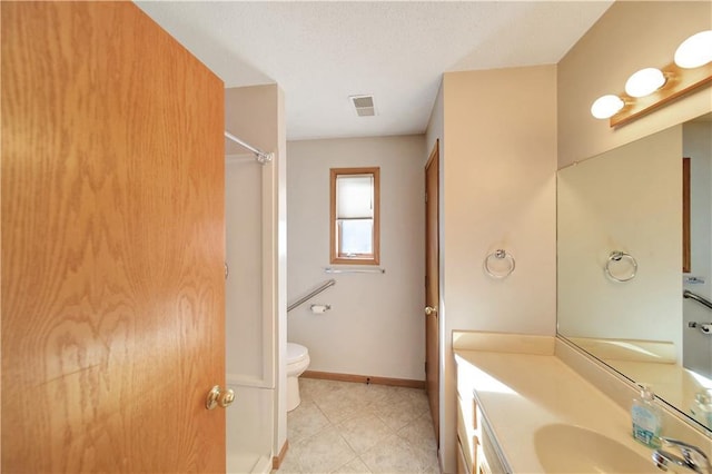 bathroom with vanity, toilet, and tile patterned flooring