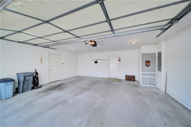 garage with a garage door opener and electric panel