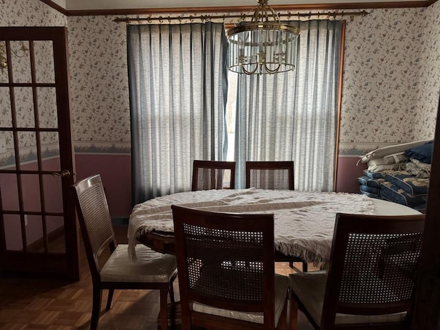 dining space featuring parquet floors and a chandelier