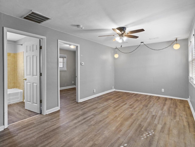 spare room with hardwood / wood-style flooring and ceiling fan