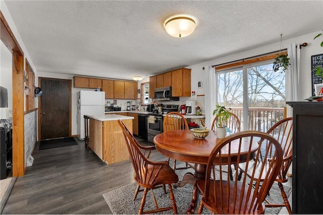 dining room featuring dark hardwood / wood-style floors and a textured ceiling