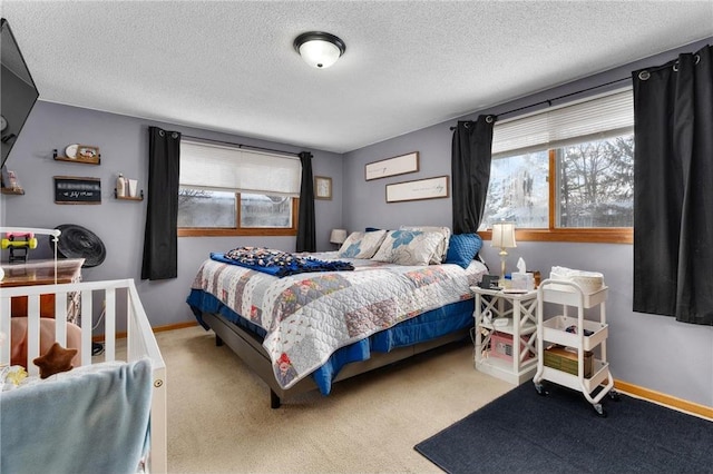 carpeted bedroom featuring a textured ceiling