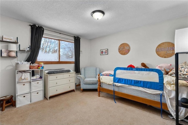 bedroom featuring light carpet and a textured ceiling