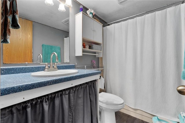 bathroom featuring a shower with shower curtain, vanity, toilet, and hardwood / wood-style floors