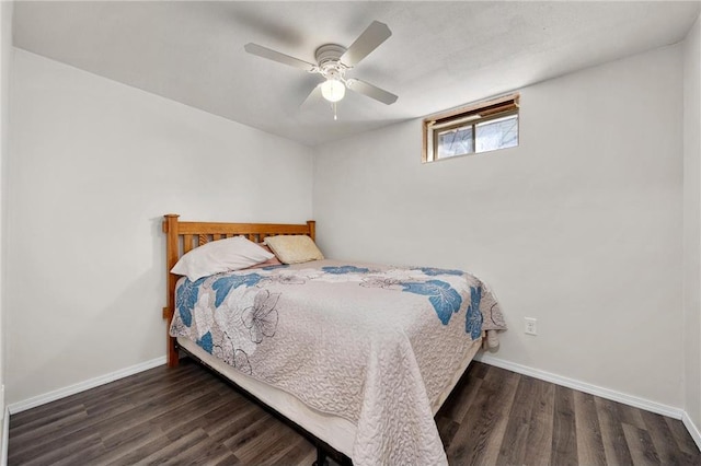 bedroom with dark hardwood / wood-style floors and ceiling fan