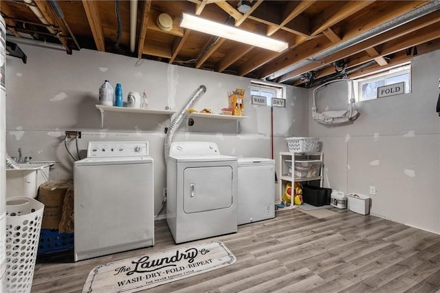 laundry area featuring hardwood / wood-style flooring and separate washer and dryer