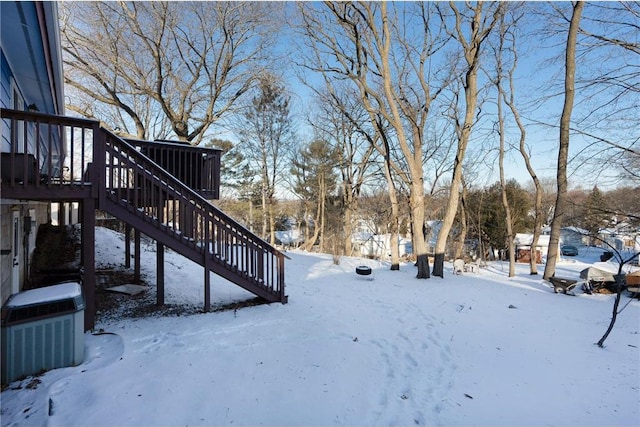 yard layered in snow featuring central AC unit