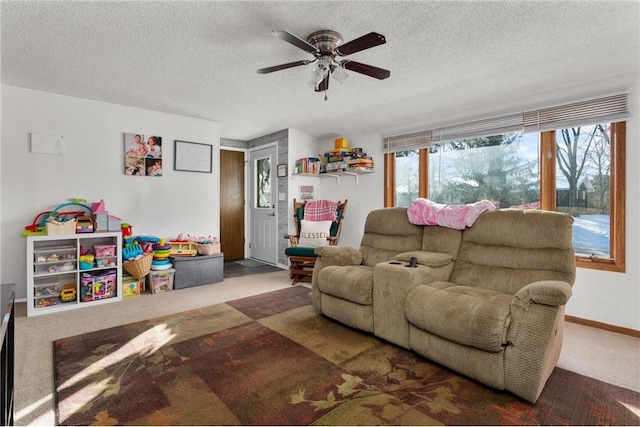 living room featuring ceiling fan, carpet flooring, and a textured ceiling